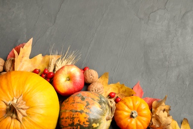 Photo of Flat lay composition with ripe pumpkins and autumn leaves on grey table, space for text. Happy Thanksgiving day