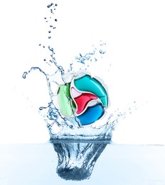Image of Laundry capsule falling into water on white background. Detergent pod