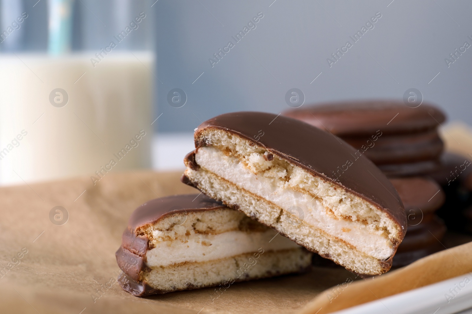 Photo of Tasty choco pies on parchment paper, closeup view