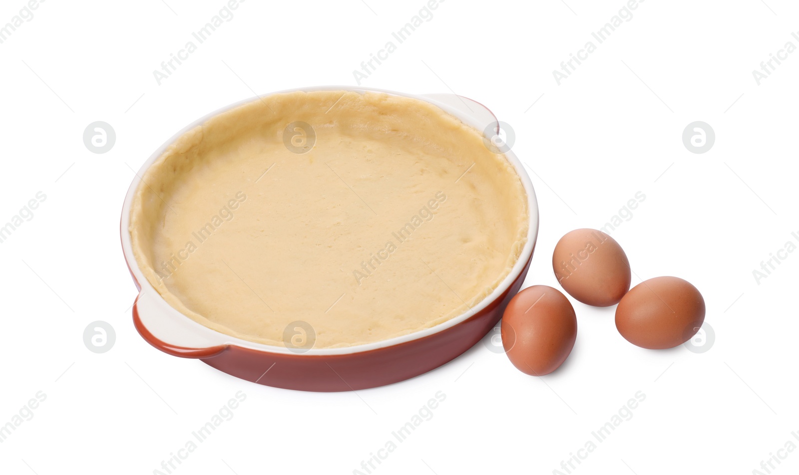 Photo of Pie tin with fresh dough and eggs isolated on white. Making quiche