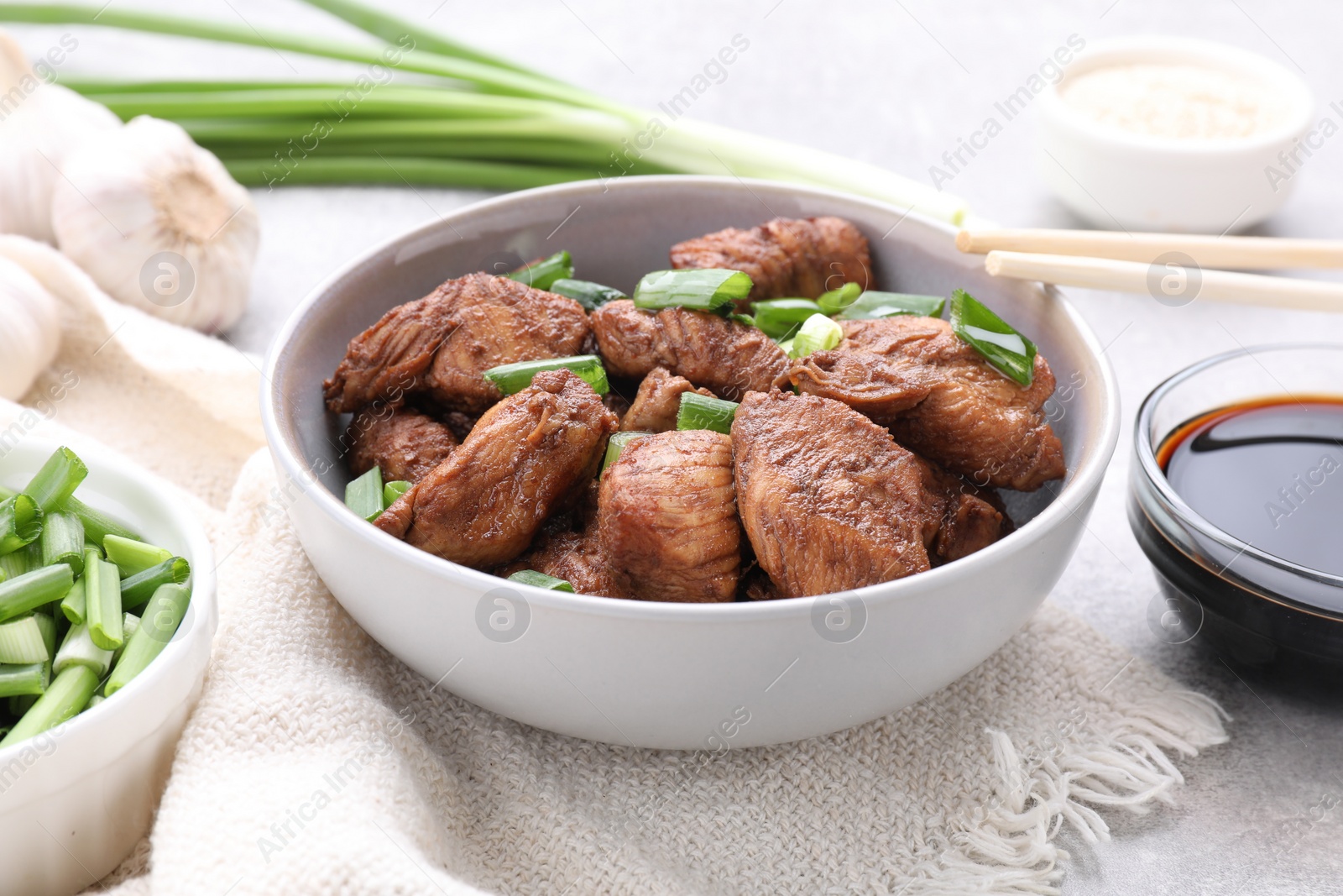 Photo of Tasty soy sauce and roasted meat on table, closeup