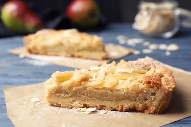 Piece of delicious sweet pear tart on table, closeup