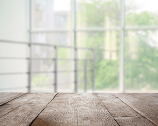 Image of Empty wooden surface and blurred view of modern window 