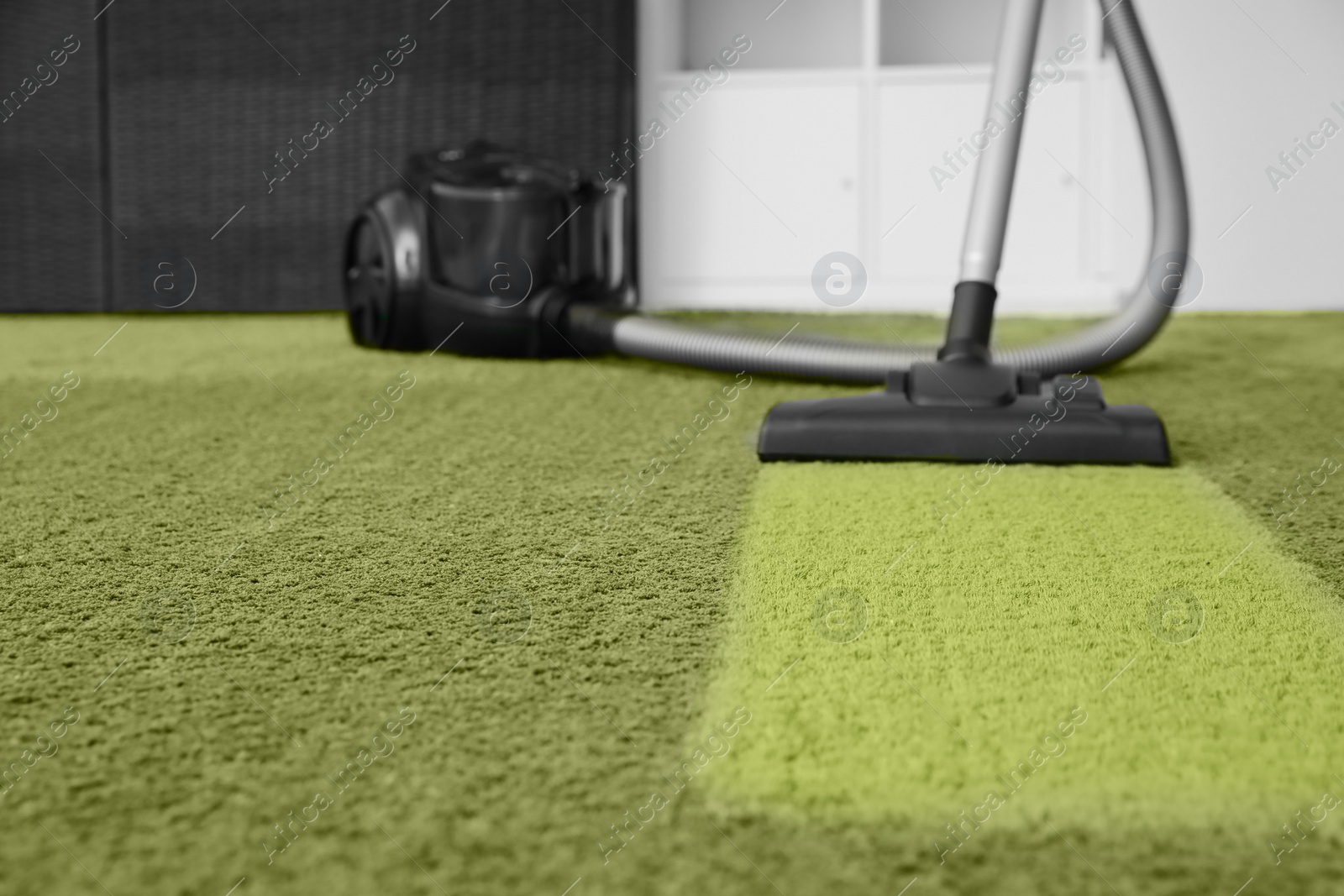 Image of Vacuuming carpet. Clean area after using device in room