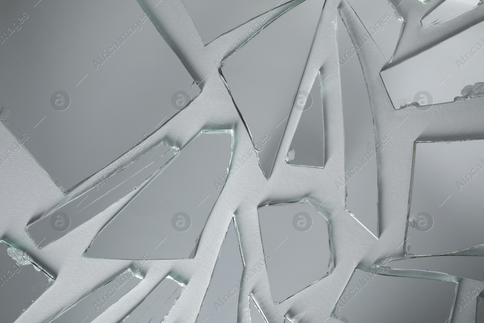 Photo of Shards of broken mirror on white background, top view