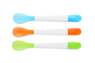 Plastic spoons isolated on white, top view. Serving baby food