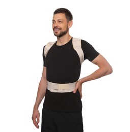 Photo of Handsome man with orthopedic corset on white background