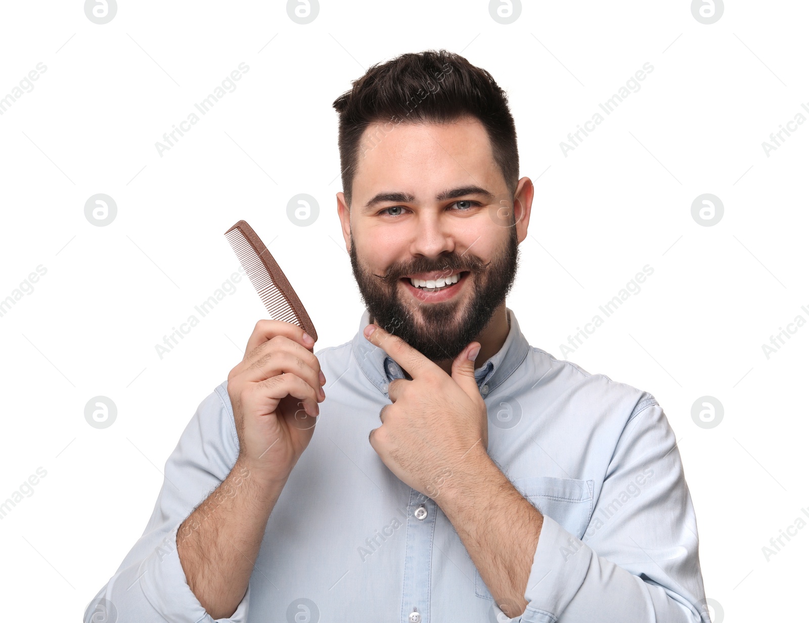 Photo of Handsome young man with mustache holding comb on white background