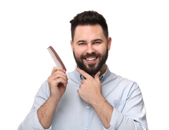 Photo of Handsome young man with mustache holding comb on white background