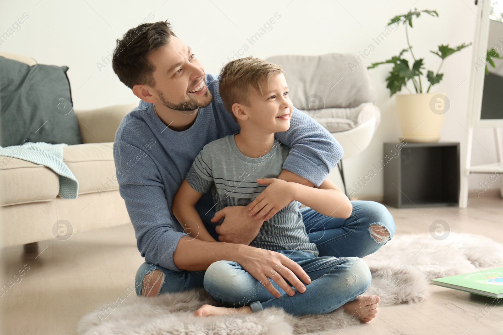 Photo of Little boy and his dad spending time together at home