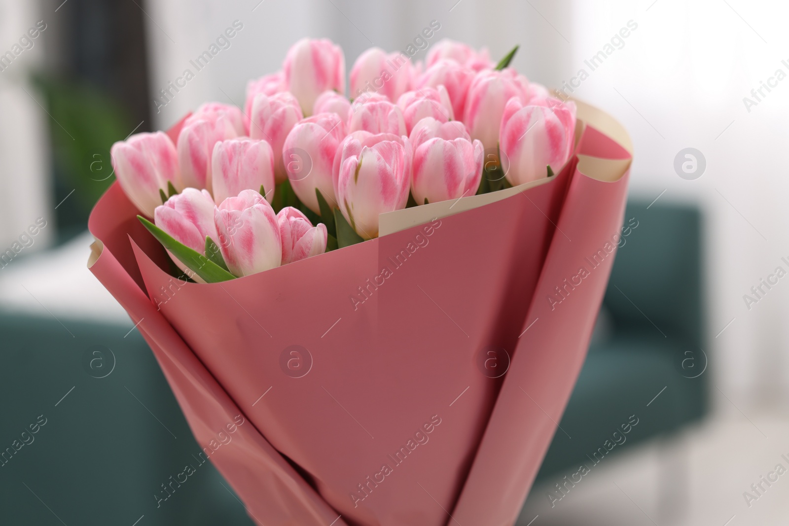 Photo of Beautiful bouquet of fresh pink tulips at home, closeup