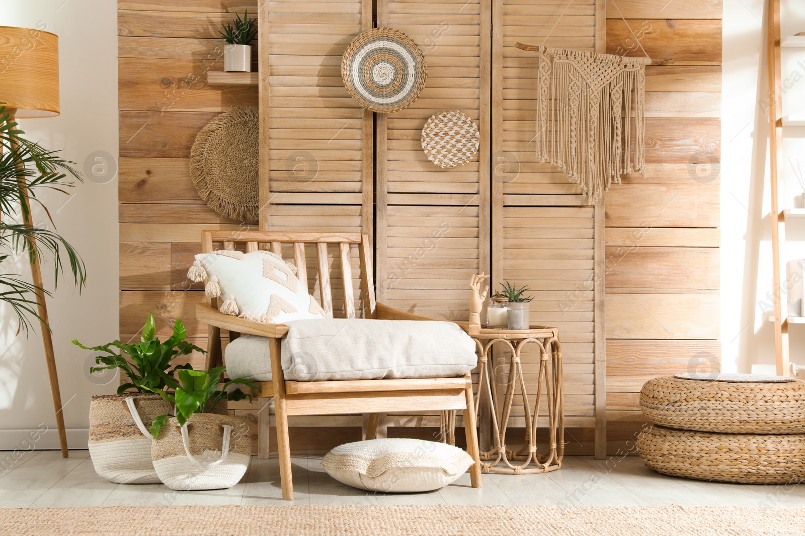 Photo of Stylish living room interior with comfortable wooden armchair and beautiful houseplants