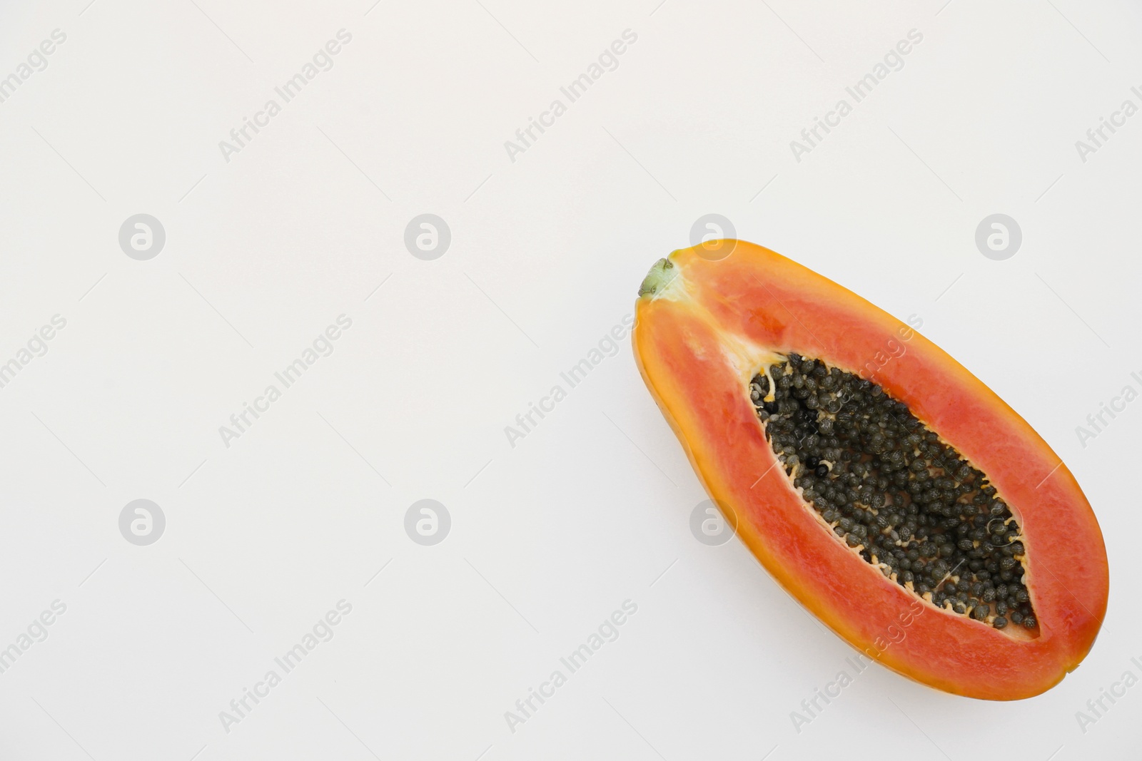 Photo of Half of fresh ripe papaya fruit on white background, top view. Space for text