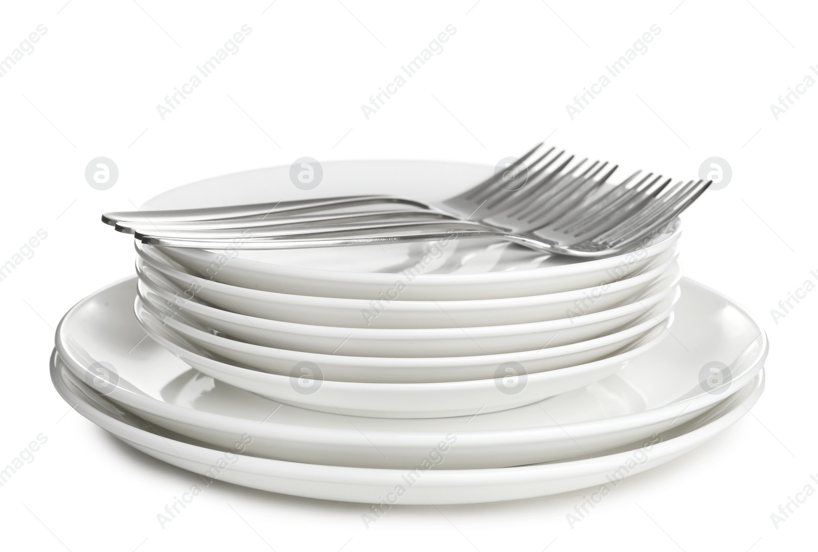 Photo of Stack of ceramic dishware with cutlery on white background