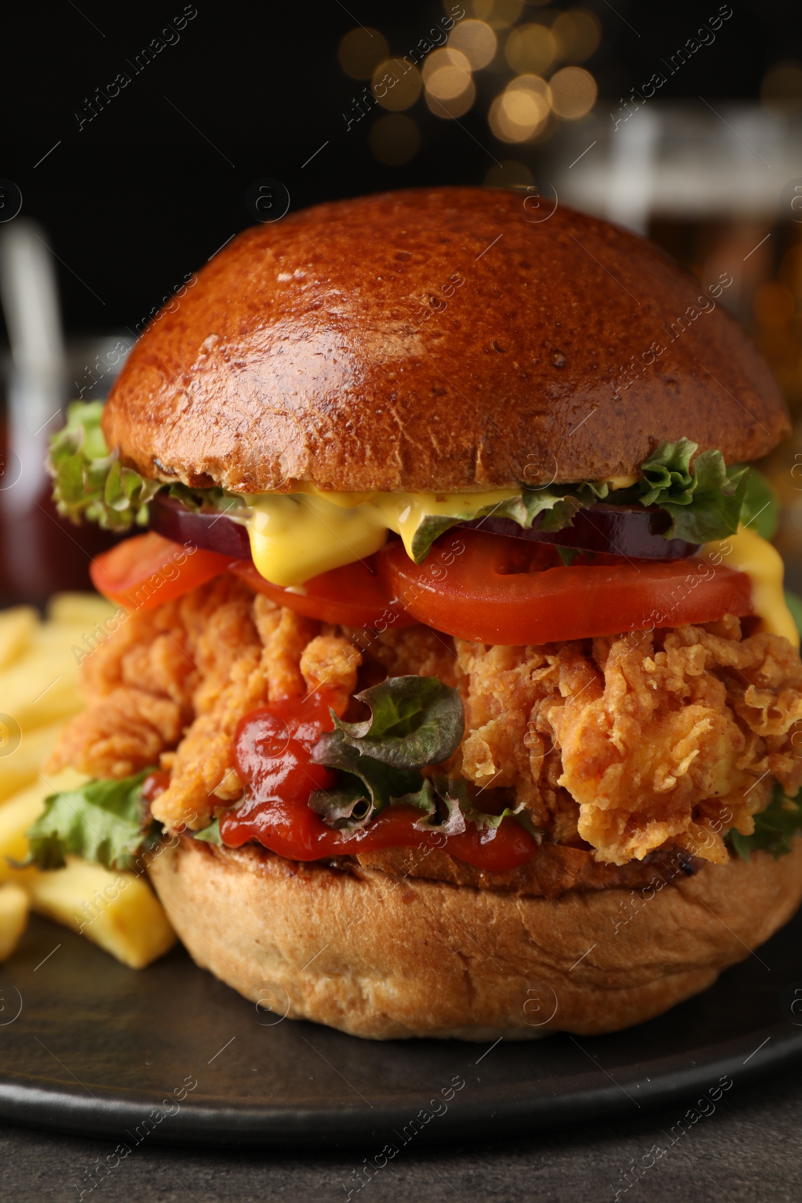 Photo of Delicious burger with crispy chicken patty on table, closeup