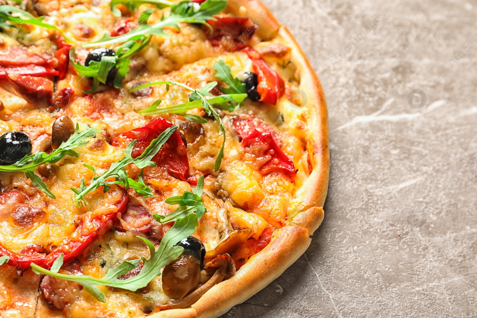 Photo of Delicious pizza with olives and sausages on table