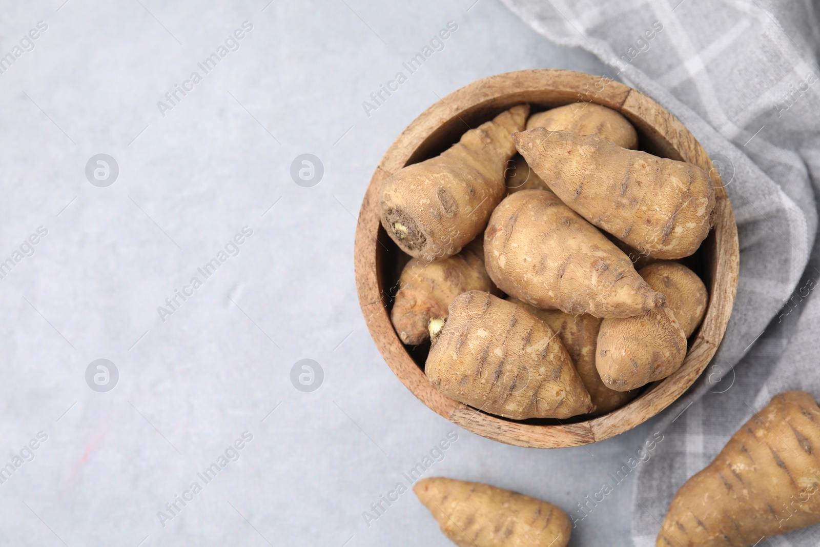 Photo of Tubers of turnip rooted chervil on light grey table, top view. Space for text