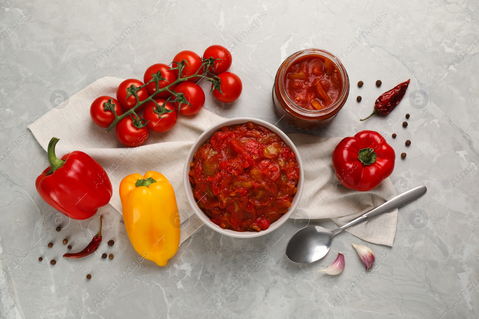 Photo of Delicious lecho and fresh ingredients on light grey marble table, flat lay