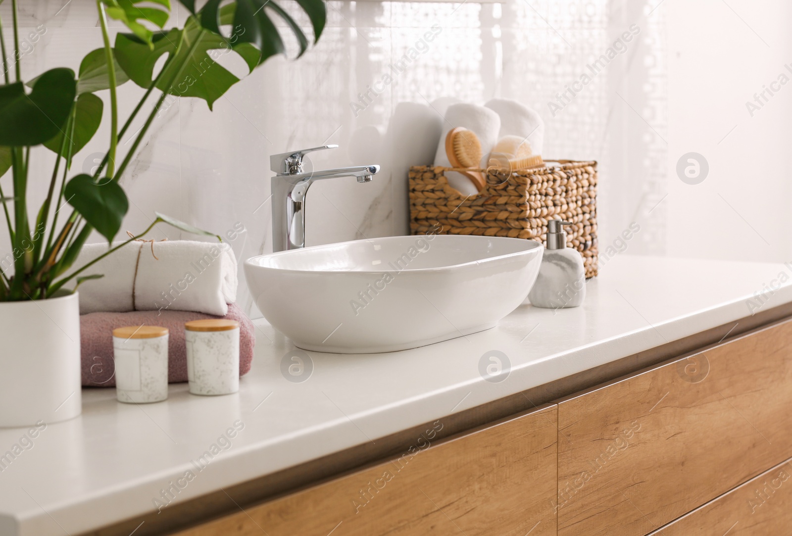 Photo of Stylish vessel sink on light countertop in modern bathroom