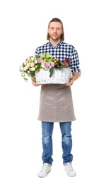 Male florist holding basket with flowers on white background