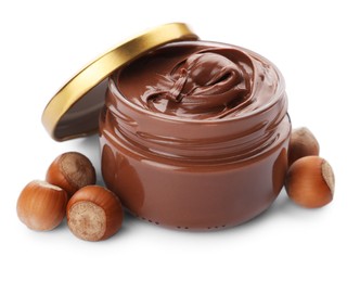 Glass jar of chocolate paste with hazelnuts on white background