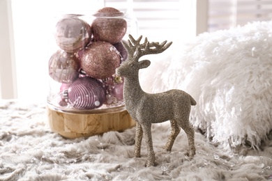 Photo of Beautiful pink Christmas baubles and deer on grey fur
