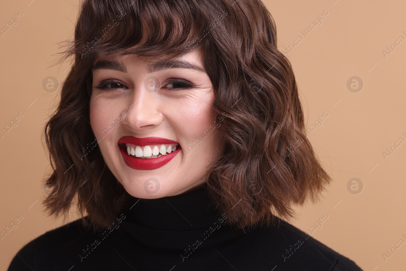 Photo of Beautiful young woman with wavy hairstyle on beige background