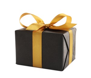 Black gift box with golden bow on white background