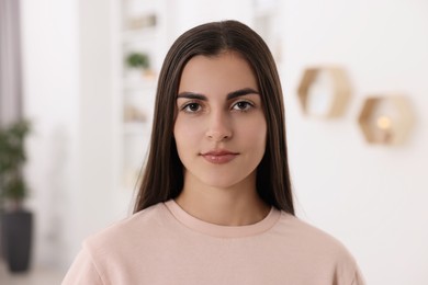 Photo of Portrait of beautiful young woman at home