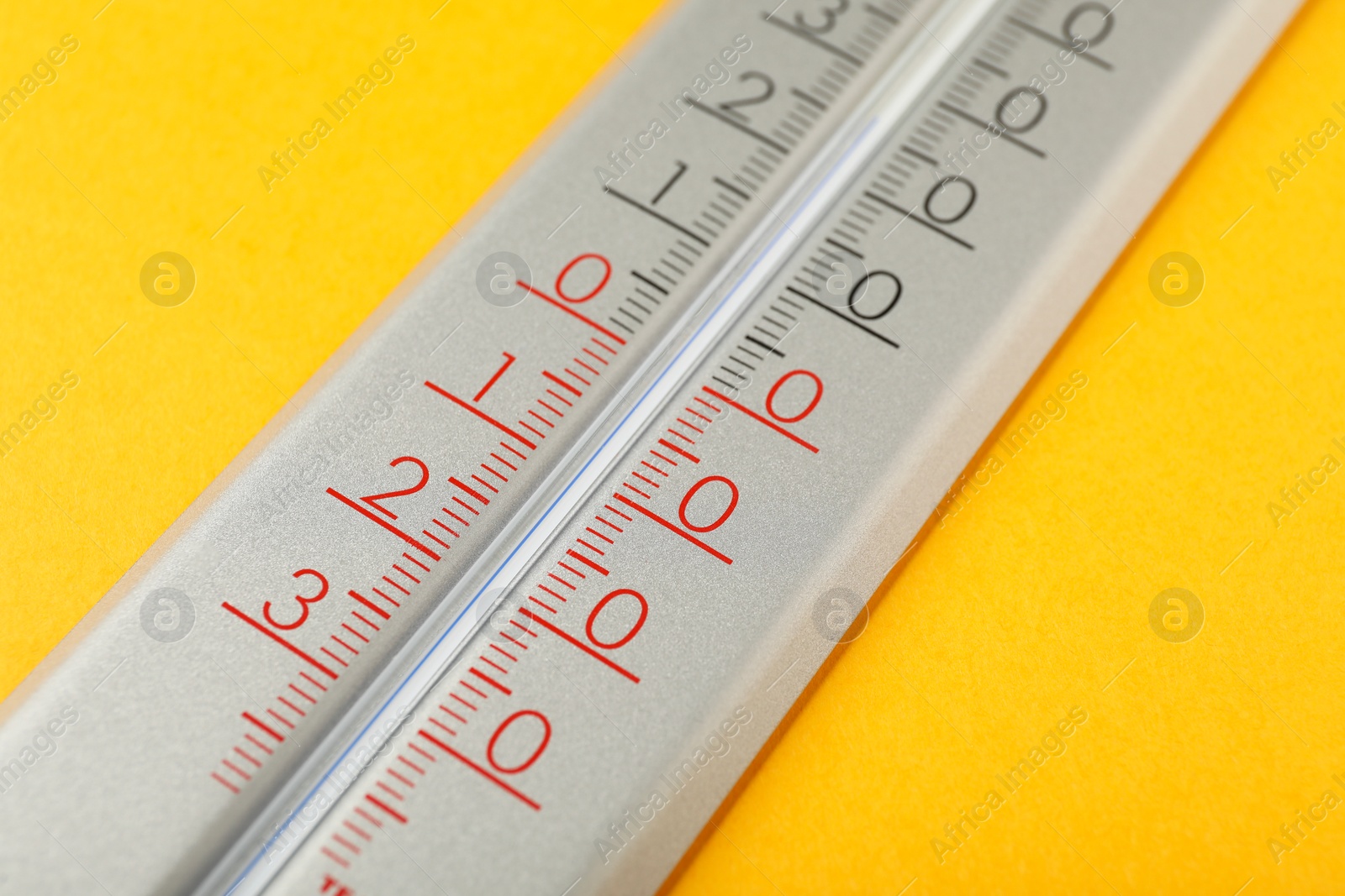 Photo of Modern weather thermometer on yellow background, closeup