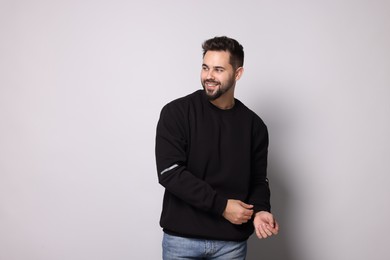 Happy man in stylish sweater on white background