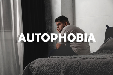 Depressed overweight man sitting alone on bed at home. Autophobia - fear of isolation