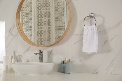 Bathroom interior with mirror, countertop and soft towel on wall