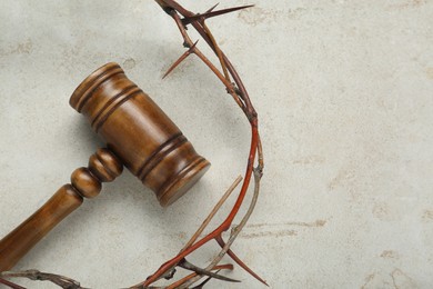 Crown of thorns and judge gavel on light grey table, flat lay. Space for text