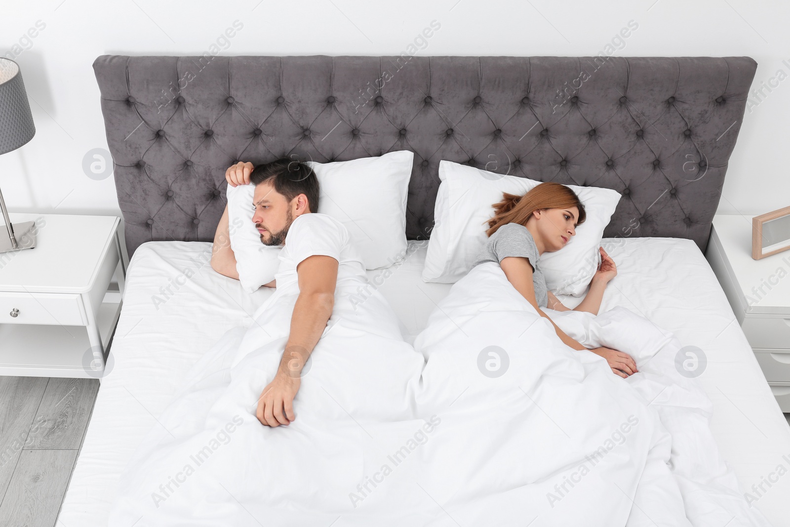 Photo of Couple with relationship problems in bed at home
