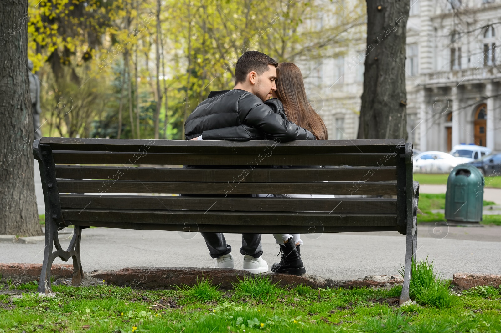 Photo of Lovely young couple on bench outdoors, back view. Romantic date