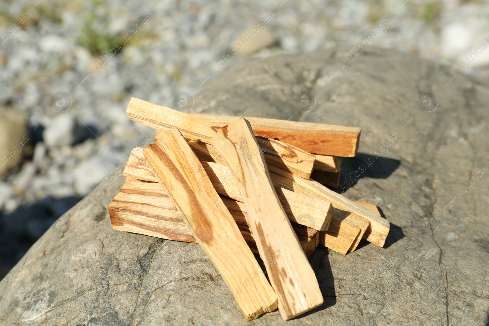 Photo of Many palo santo sticks on stone surface, closeup