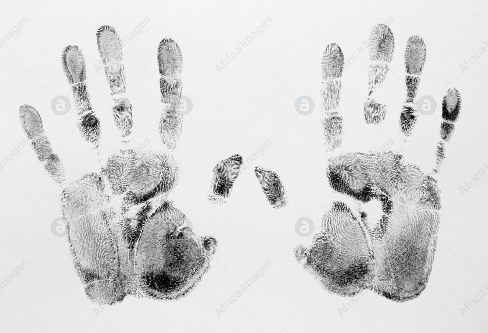 Photo of Print of hands and fingers on white background, top view. Criminal investigation