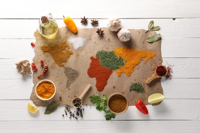 World map of different spices and products on white wooden table, top view