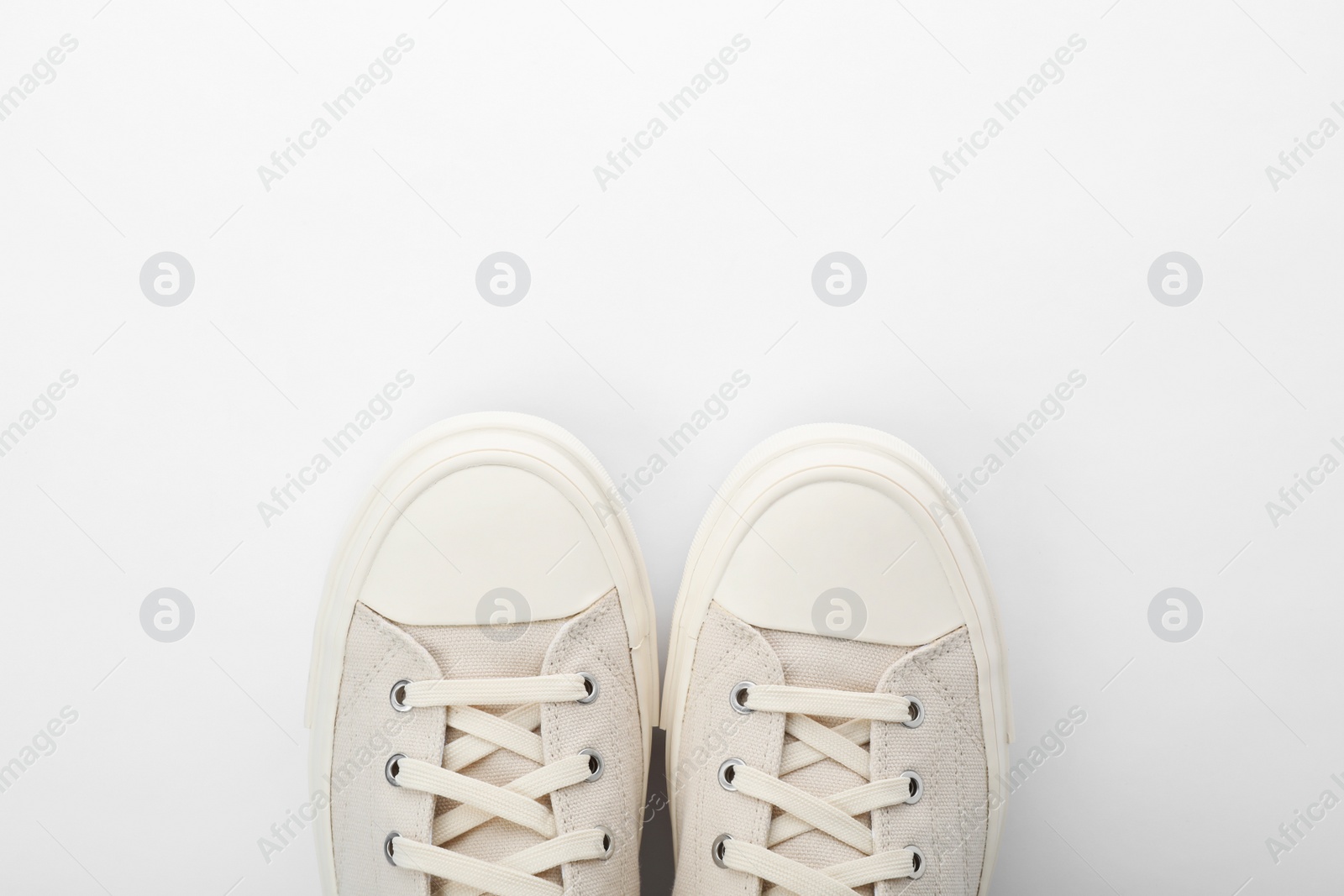 Photo of Pair of sneakers on white background, top view