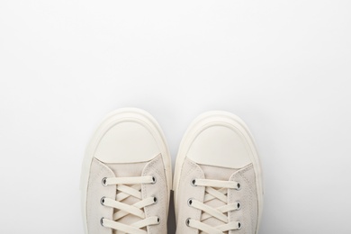 Photo of Pair of sneakers on white background, top view