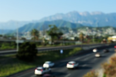 Blurred view of mountains and highway with cars