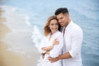 Happy couple on beach, space for text. Romantic walk