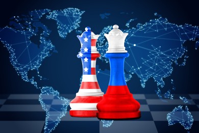 Image of Chess pieces in color of Russian and American flags against world map