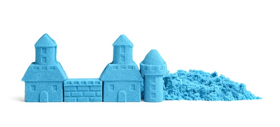 Photo of Castle made of blue kinetic sand isolated on white