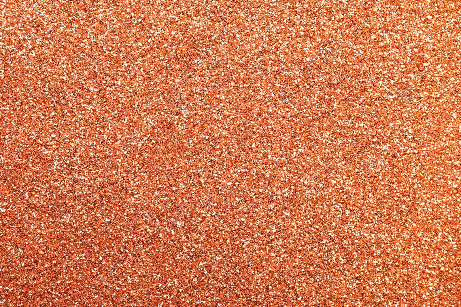 Photo of Beautiful shiny peach glitter as background, closeup