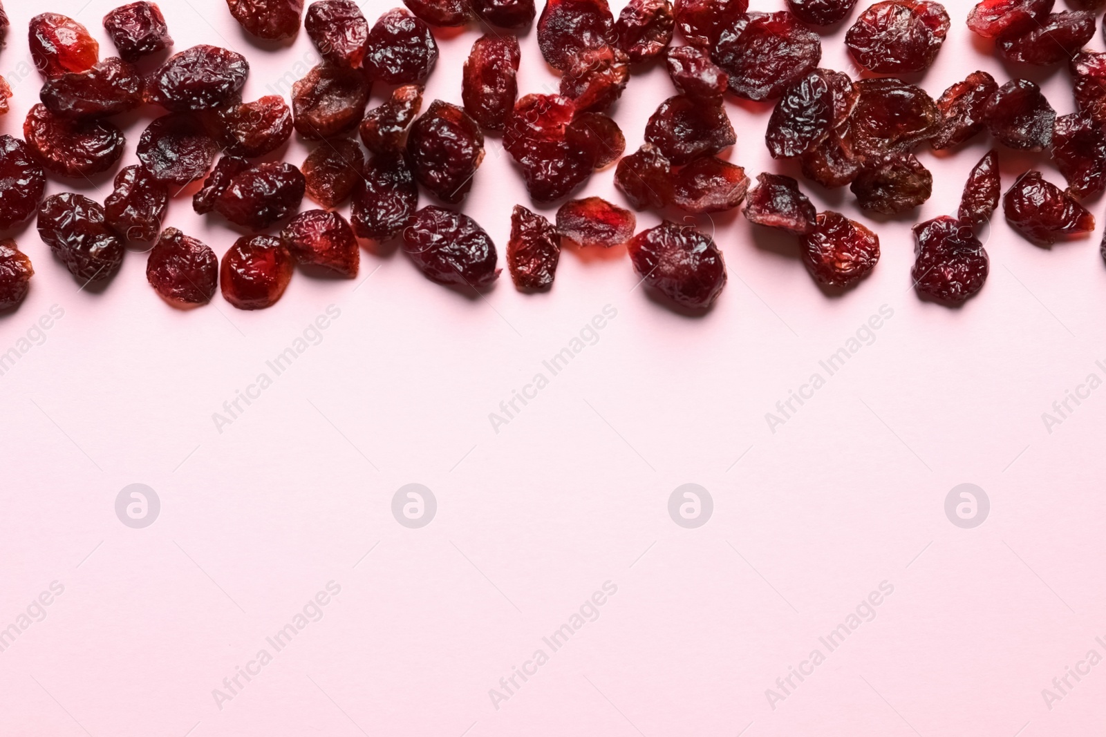 Photo of Cranberries on color background, top view with space for text. Dried fruit as healthy snack