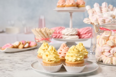 Photo of Candy bar with different sweets on white marble table. Space for text