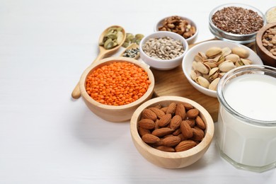 Different products high in natural fats on white wooden table, closeup