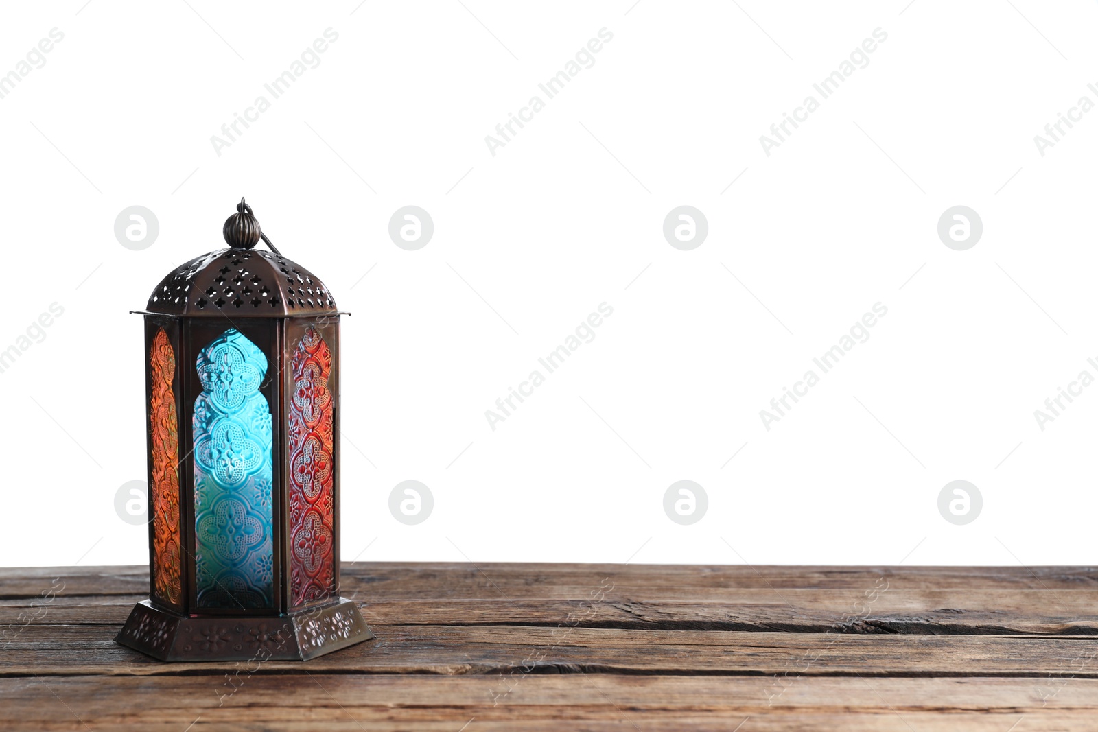 Photo of Decorative Arabic lantern on wooden table against white background